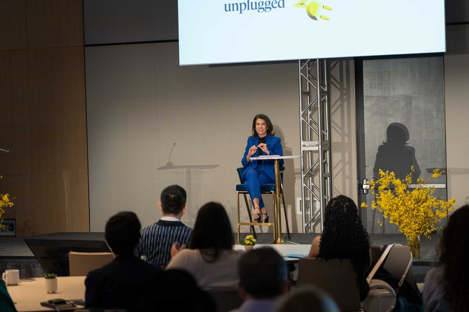 speaker on stage presenting at arnold ventures conference