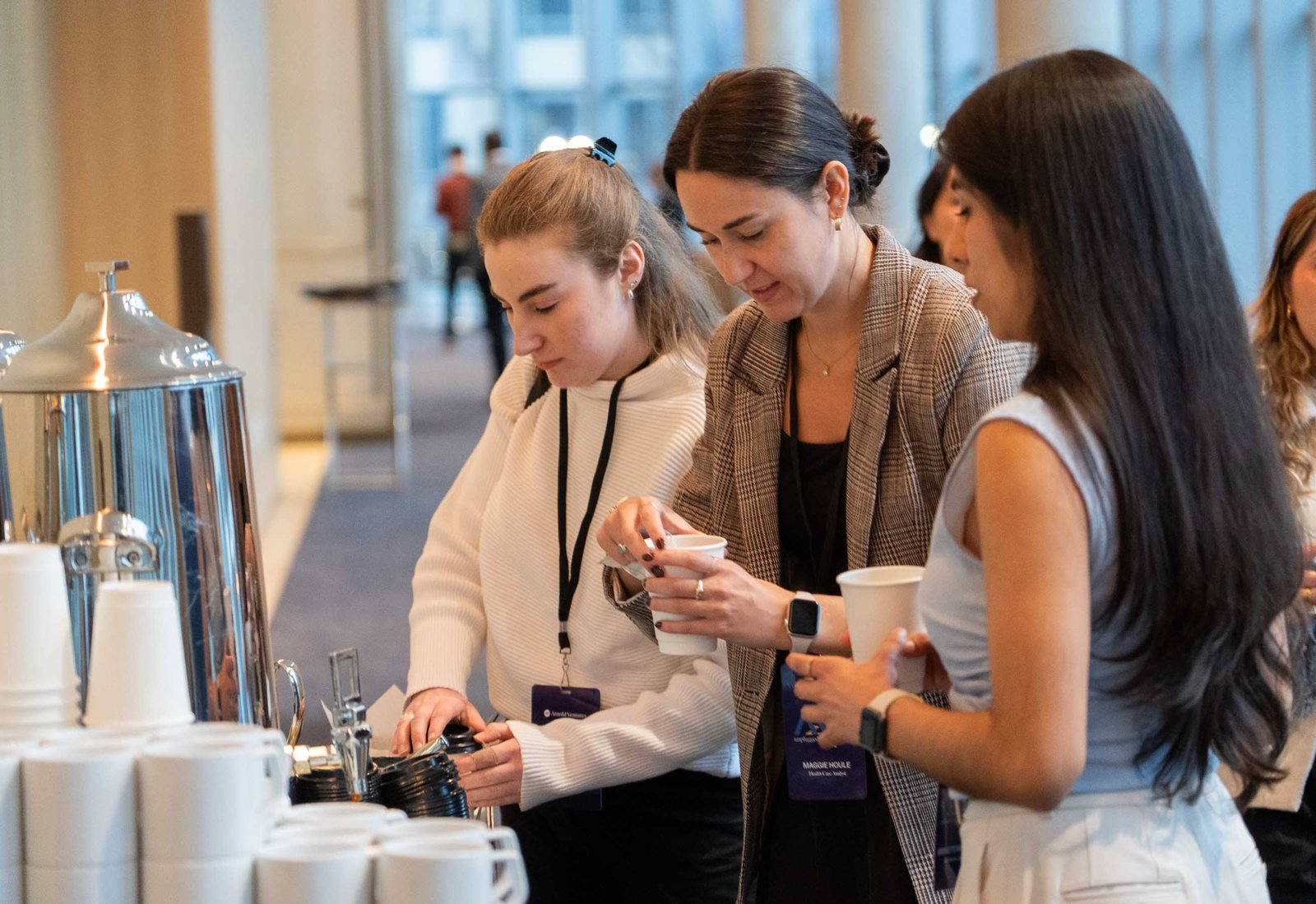 women getting coffee during break