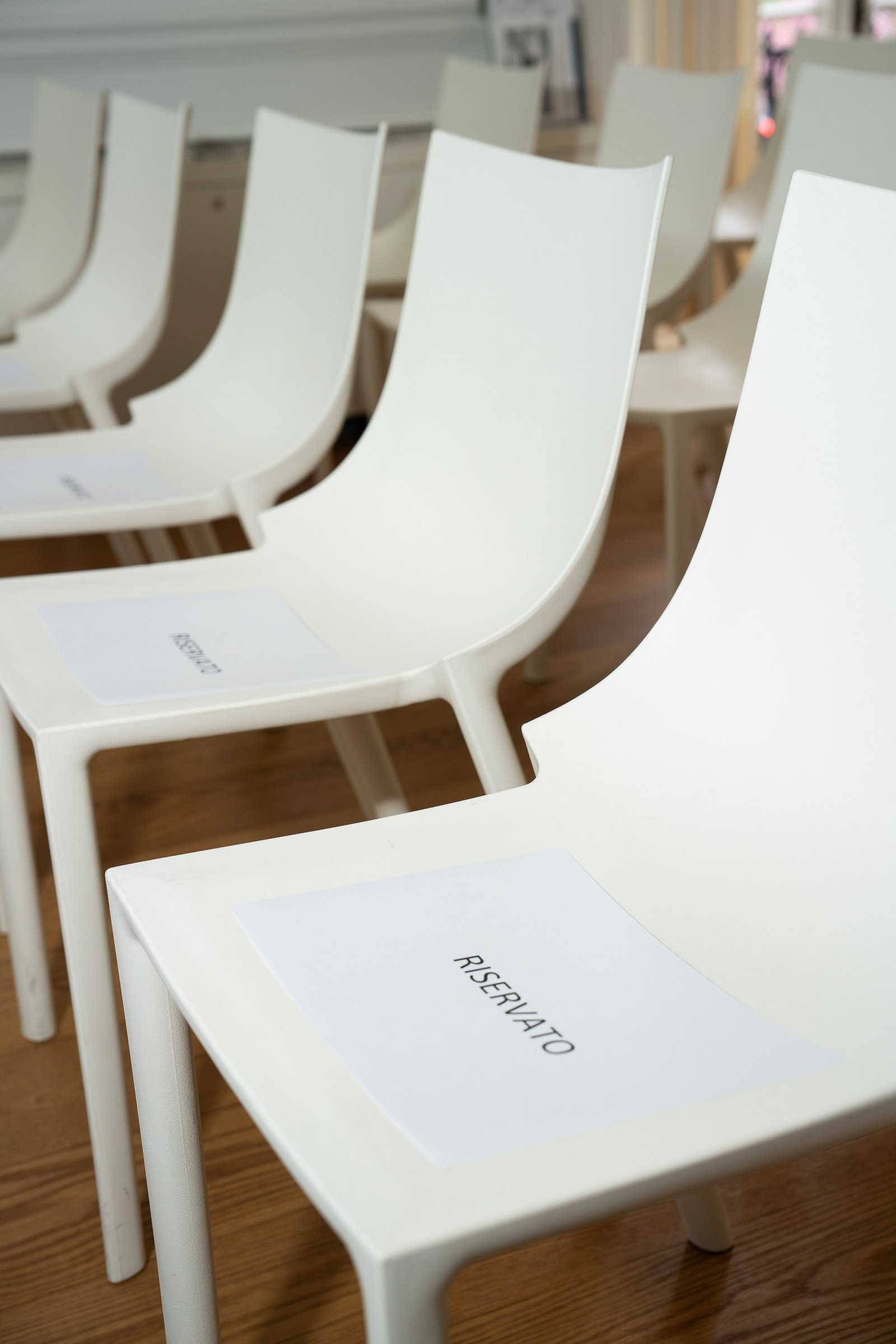 Empty white chair with place card at NIAF Italian Consulate event New York City