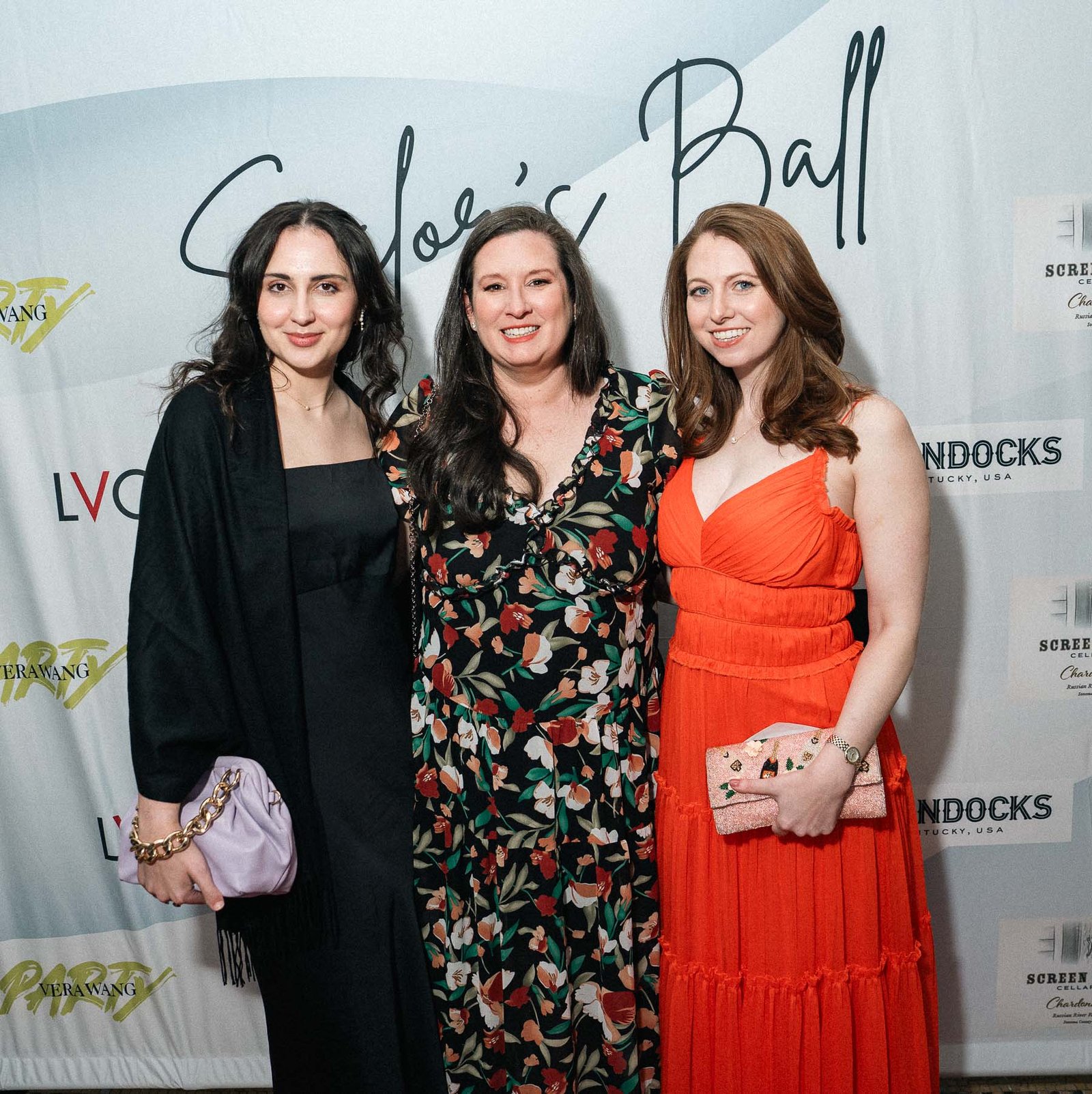 Three women in formal gowns on red carpet at Sailor's Ball 2024 New York City