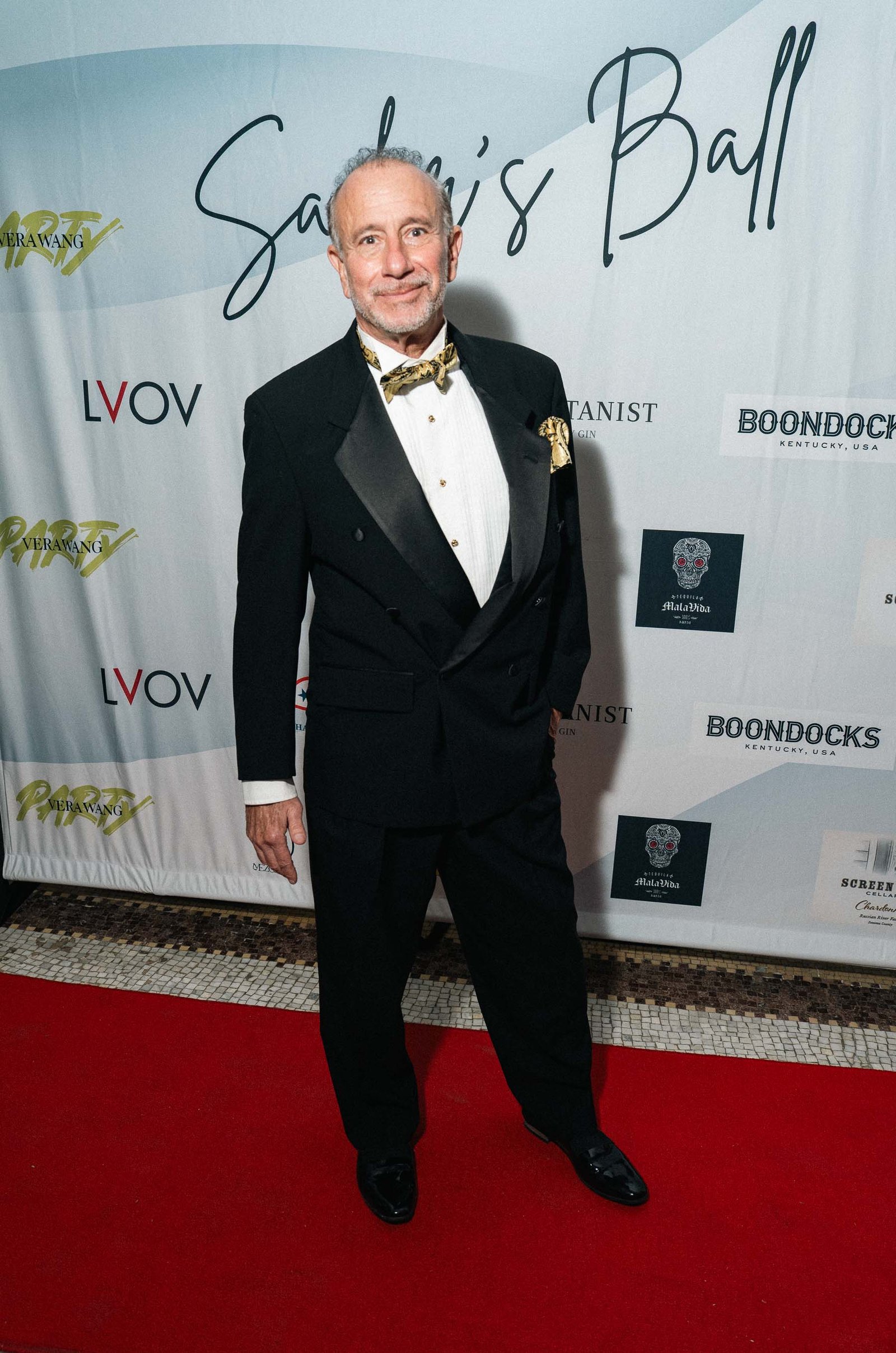 Man in tuxedo posing on red carpet at Sailor's Ball 2024 NYC gala