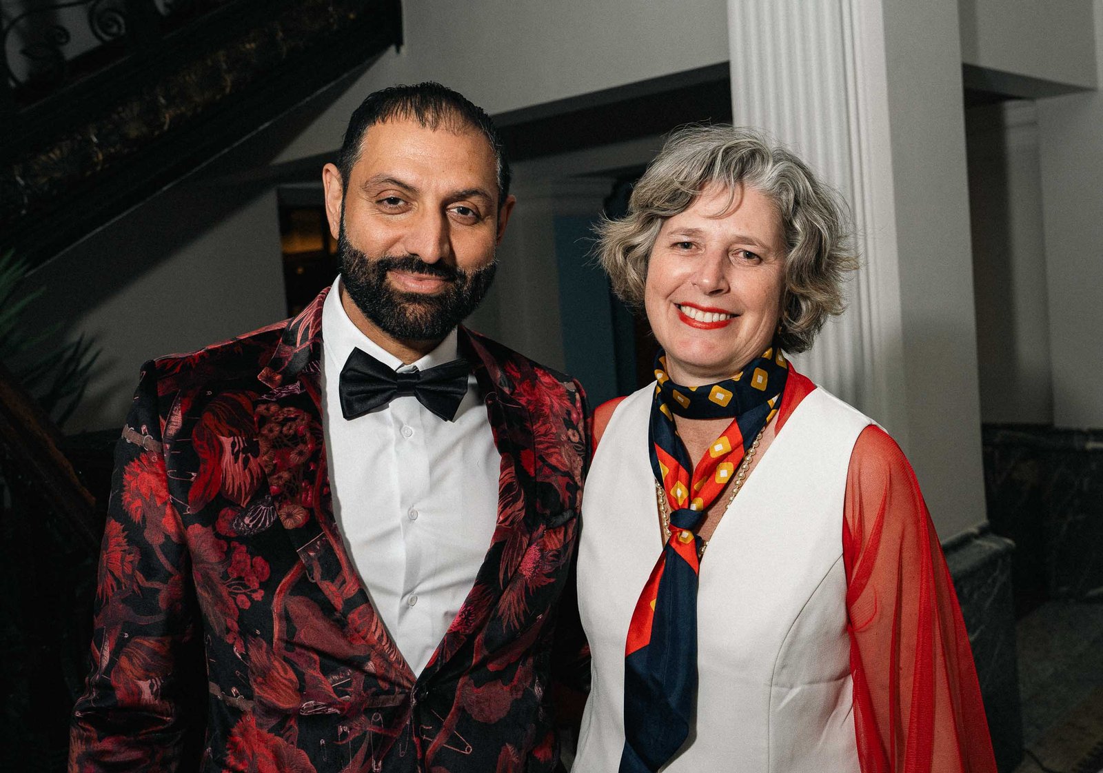 Man in floral tuxedo jacket with woman at Sailor's Ball 2024 NYC gala
