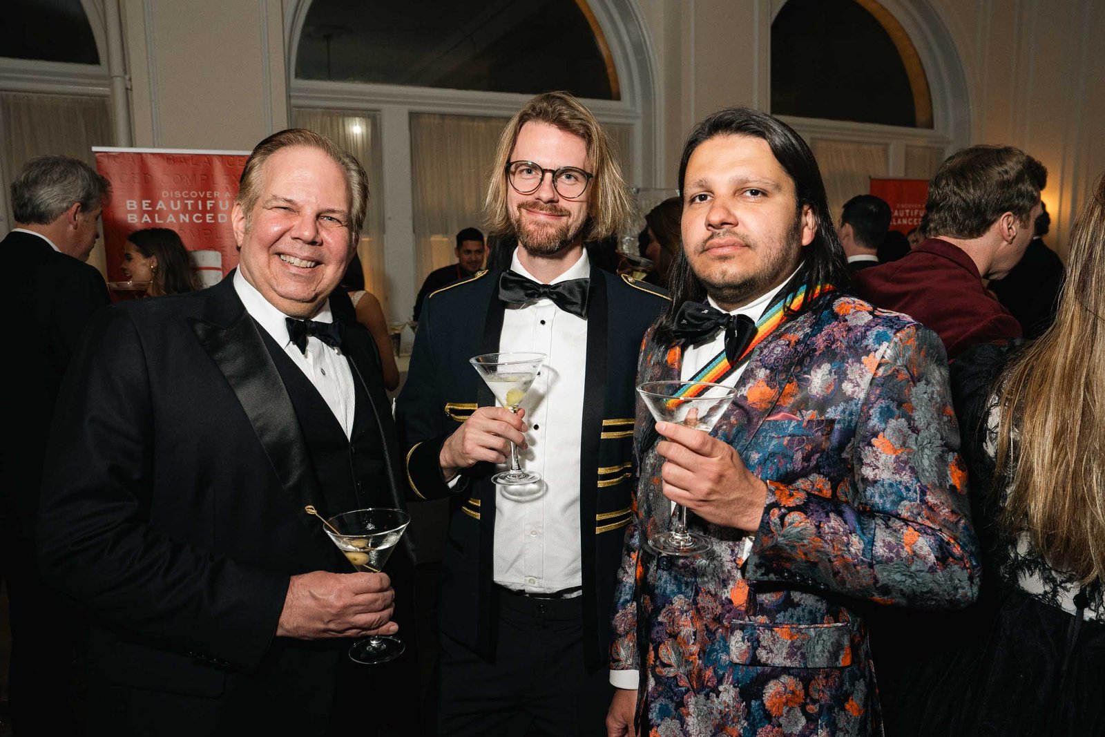 Group of men in tuxedos at casino table Sailor's Ball 2024 NYC