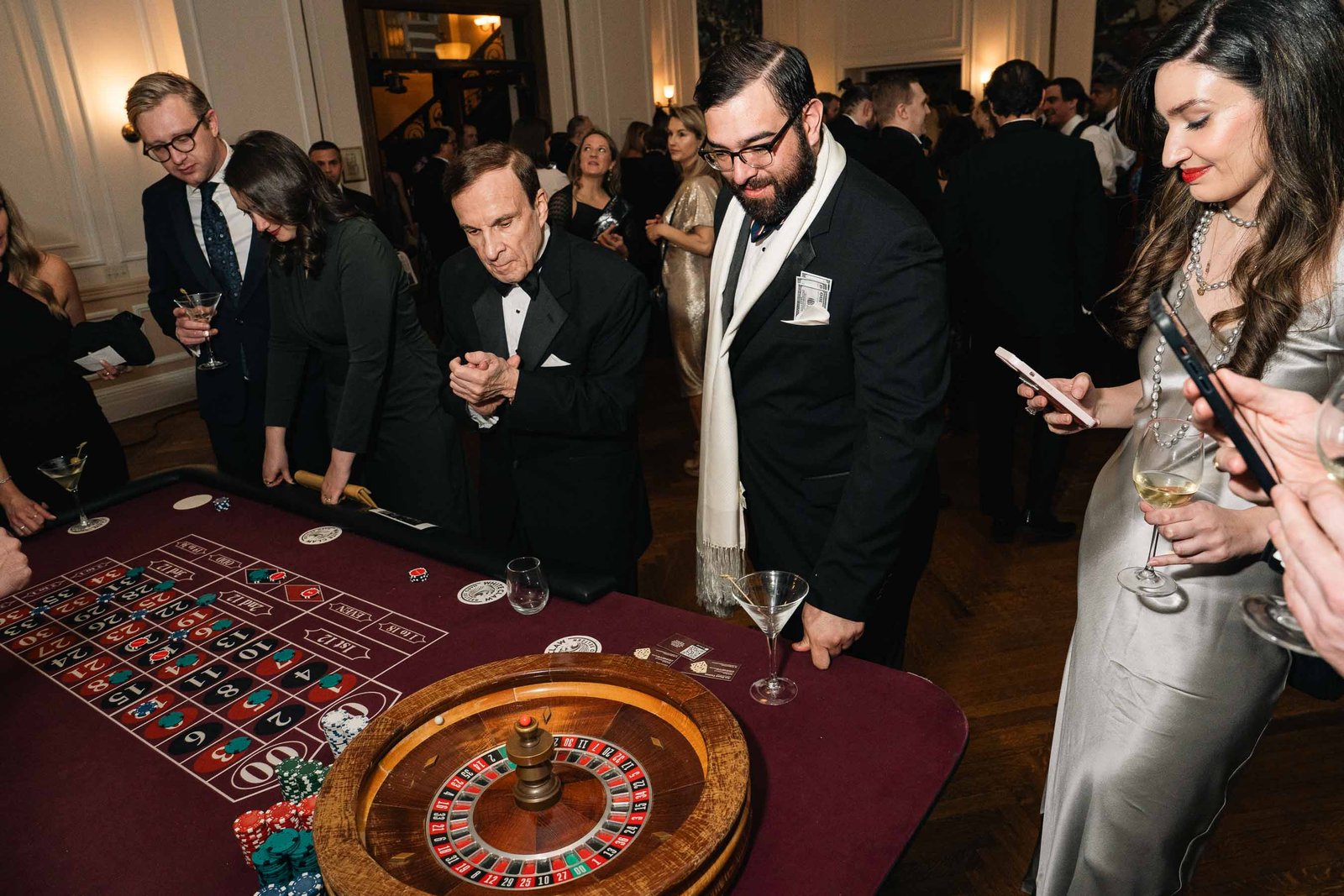 Guests at roulette table at Sailor's Ball 2024 NYC gala casino night