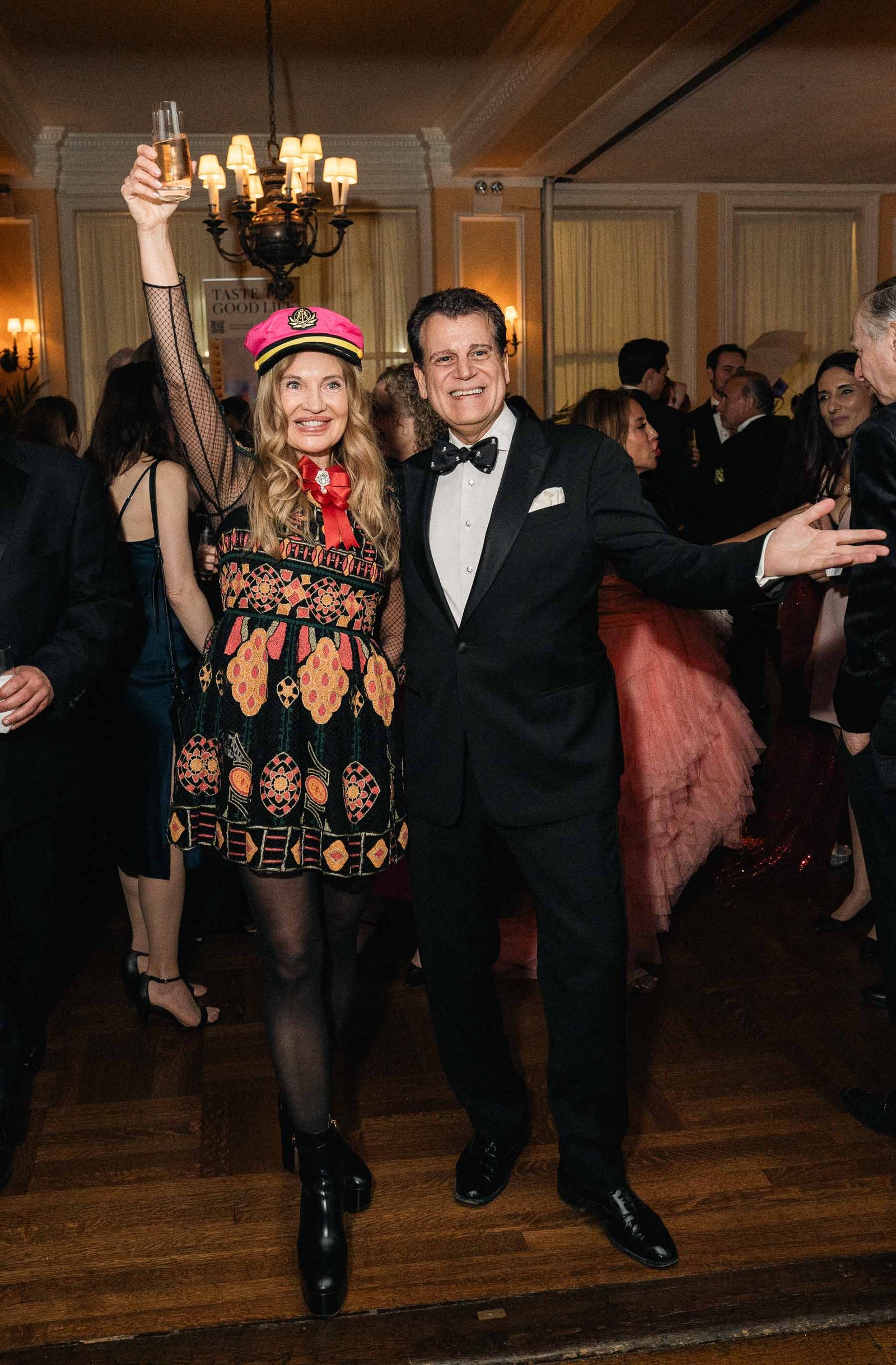 Couple in festive attire dancing at Sailor's Ball 2024 NYC gala