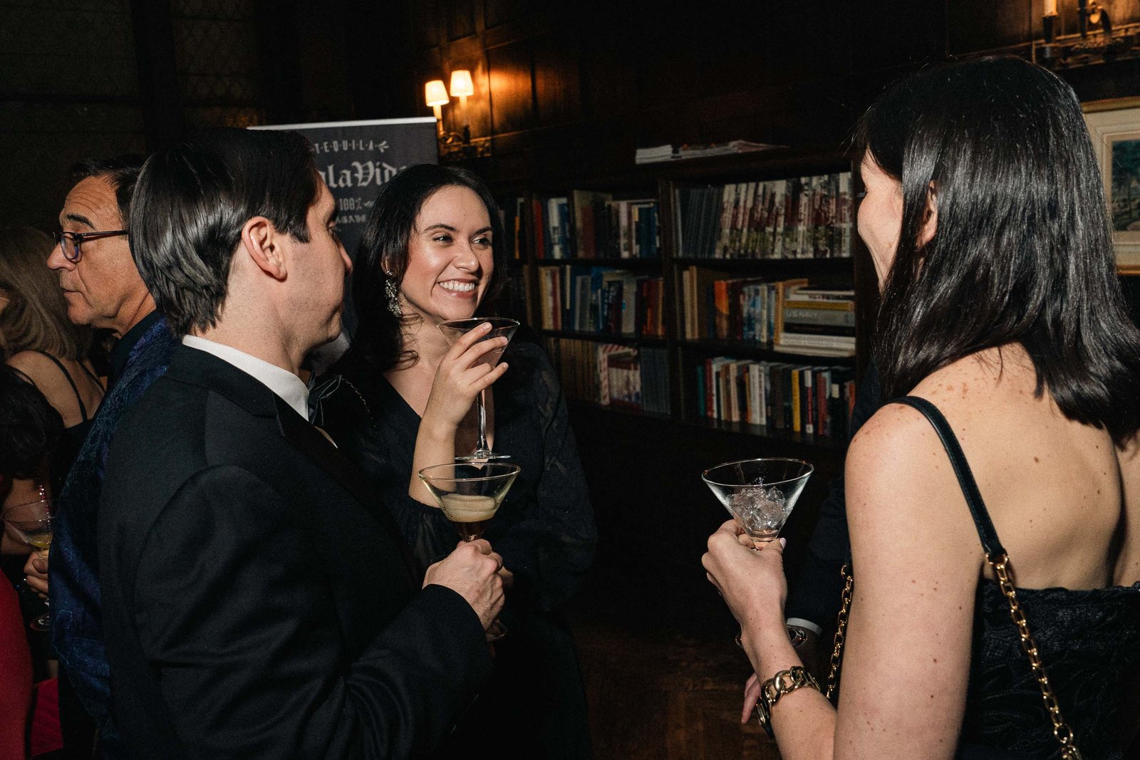 Guests networking in candlelit room at Sailor's Ball 2024 NYC event