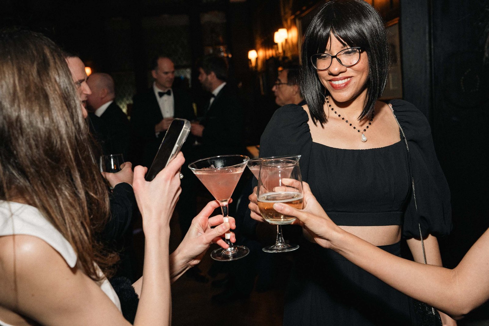 Woman toasting with cocktail at Sailor's Ball 2024 New York City gala