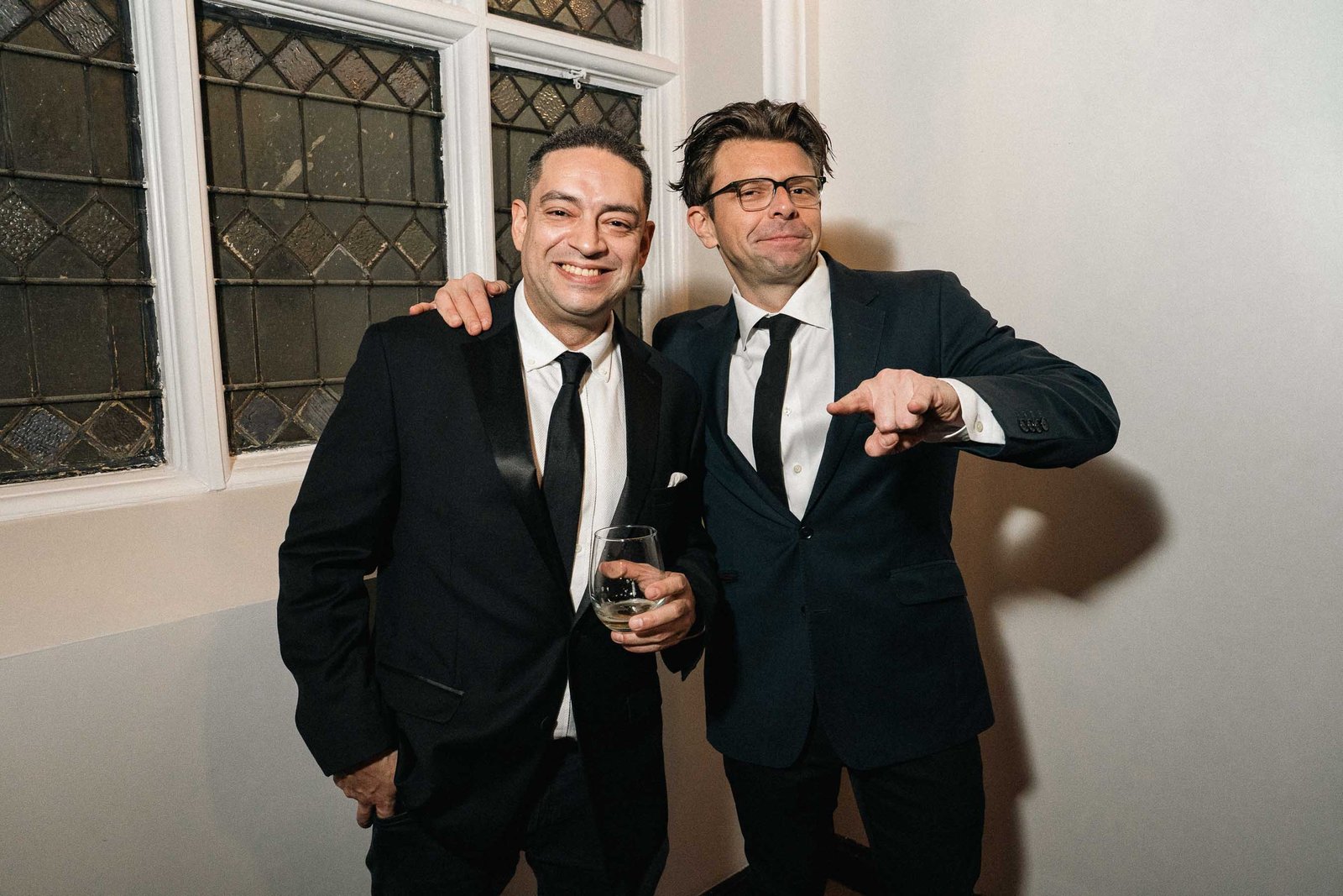 Two men in tuxedos posing at Sailor's Ball 2024 New York City