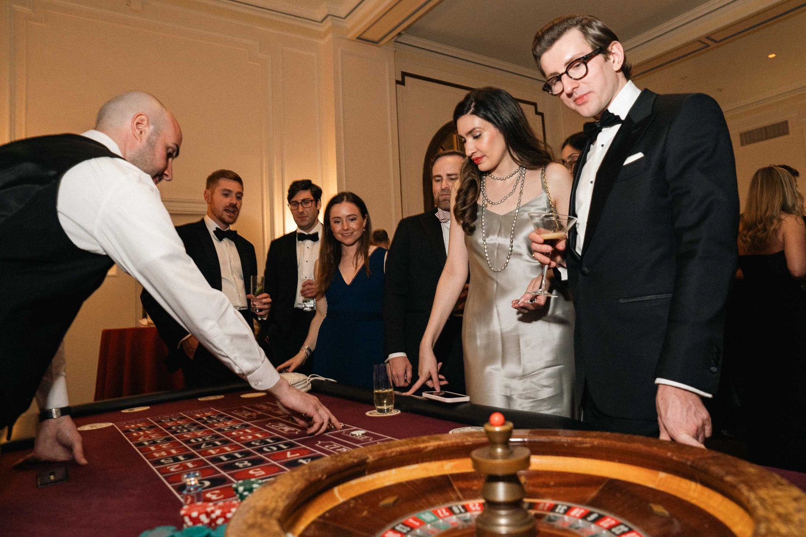 Guests at roulette table with dealer at Sailor's Ball 2024 NYC casino night