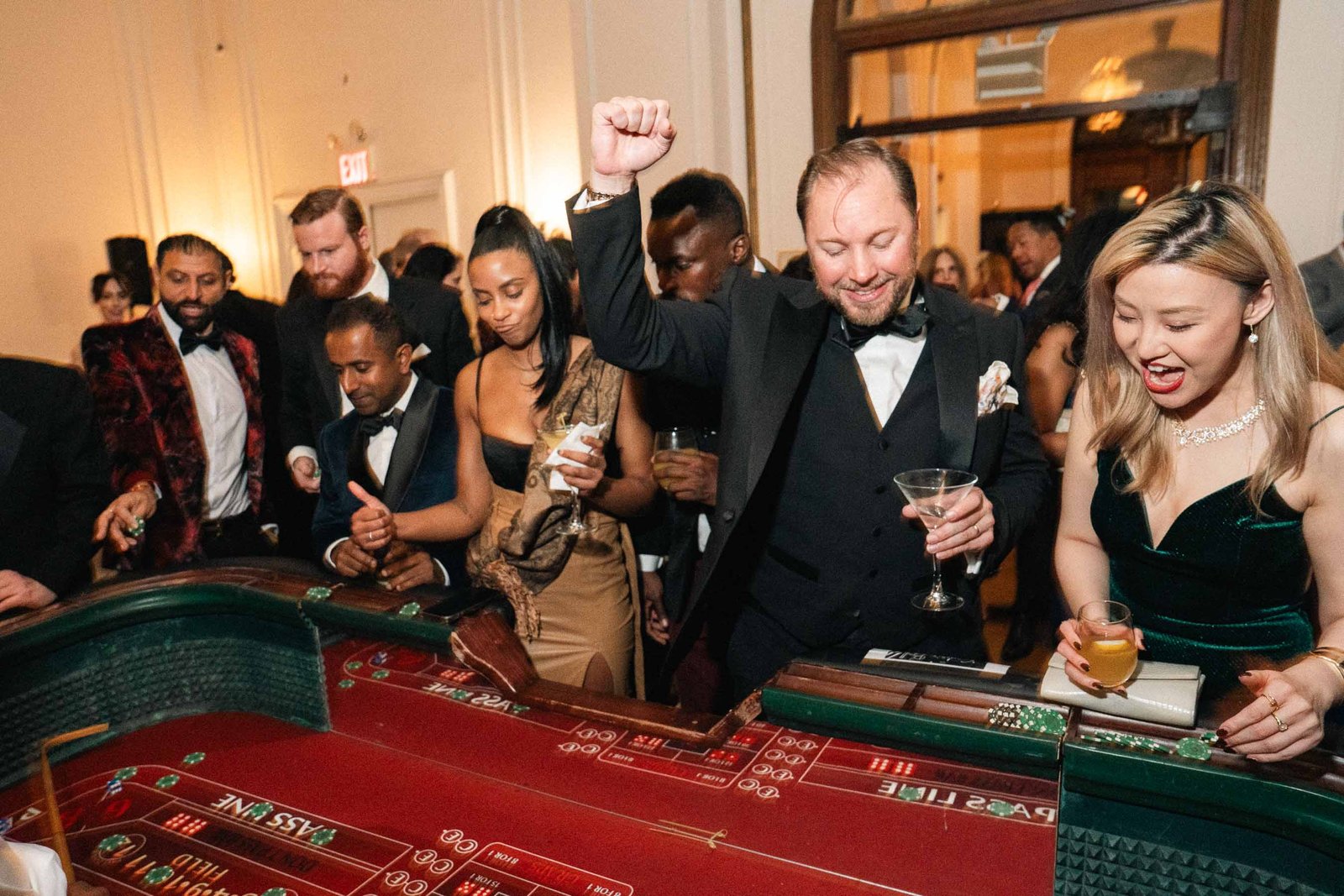 Excited guests at casino table at Sailor's Ball 2024 NYC event