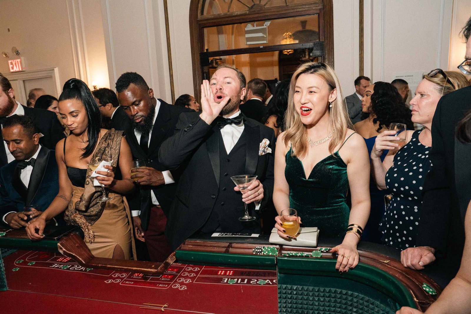 Guests laughing at casino table Sailor's Ball 2024 New York City gala