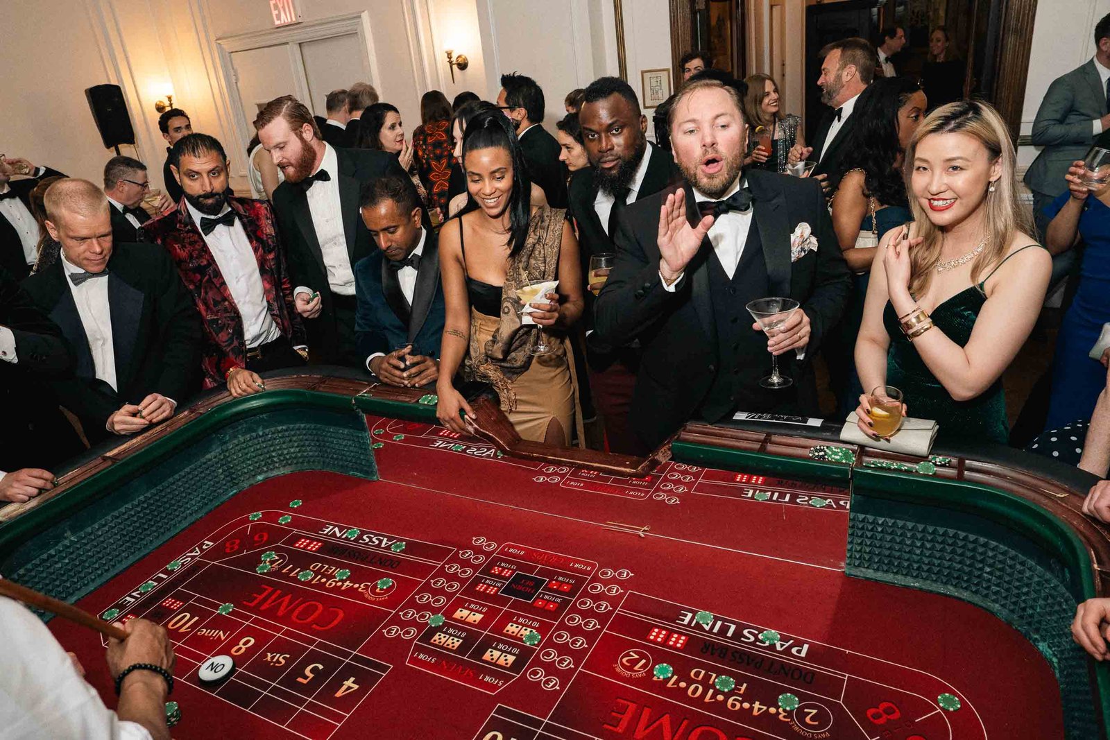Animated crowd at casino table at Sailor's Ball 2024 NYC
