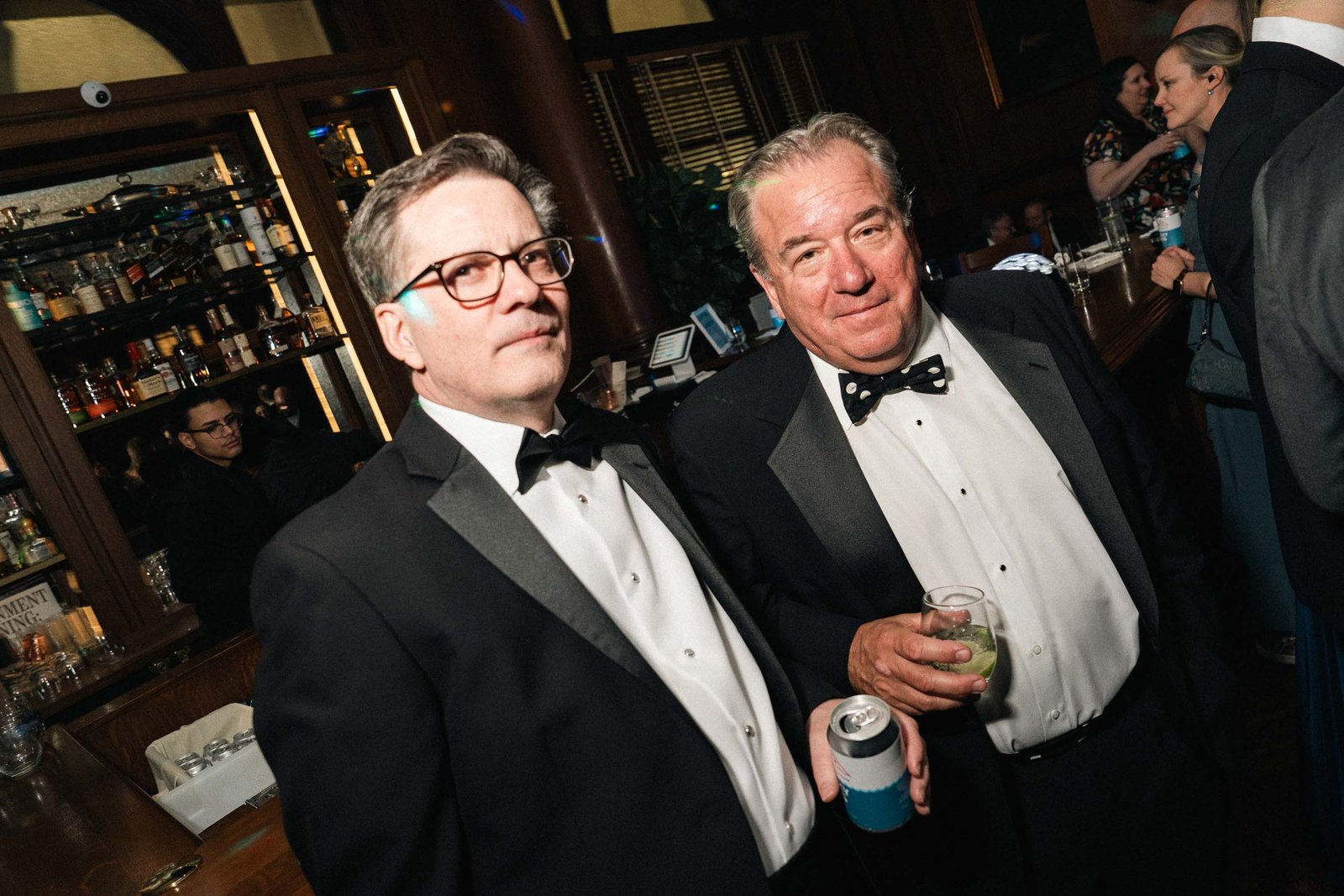 Two older gentlemen in tuxedos at Sailor's Ball 2024 NYC ballroom