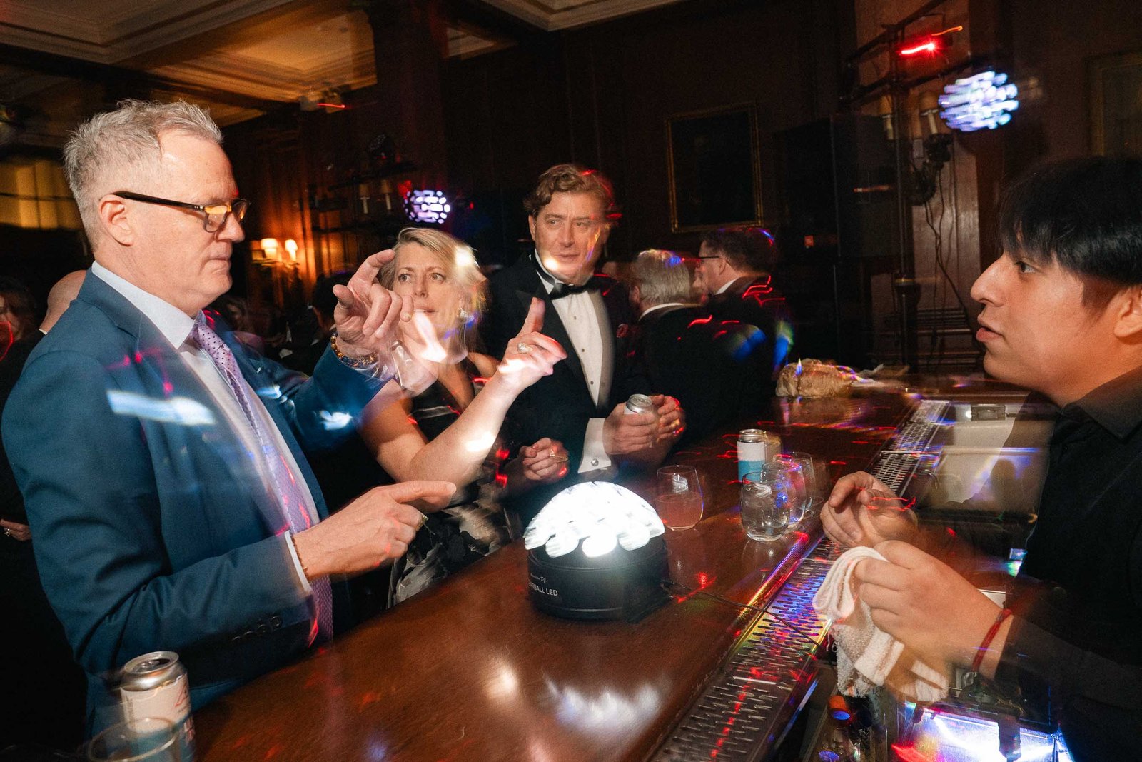 Guests at bar with disco ball at Sailor's Ball 2024 NYC gala