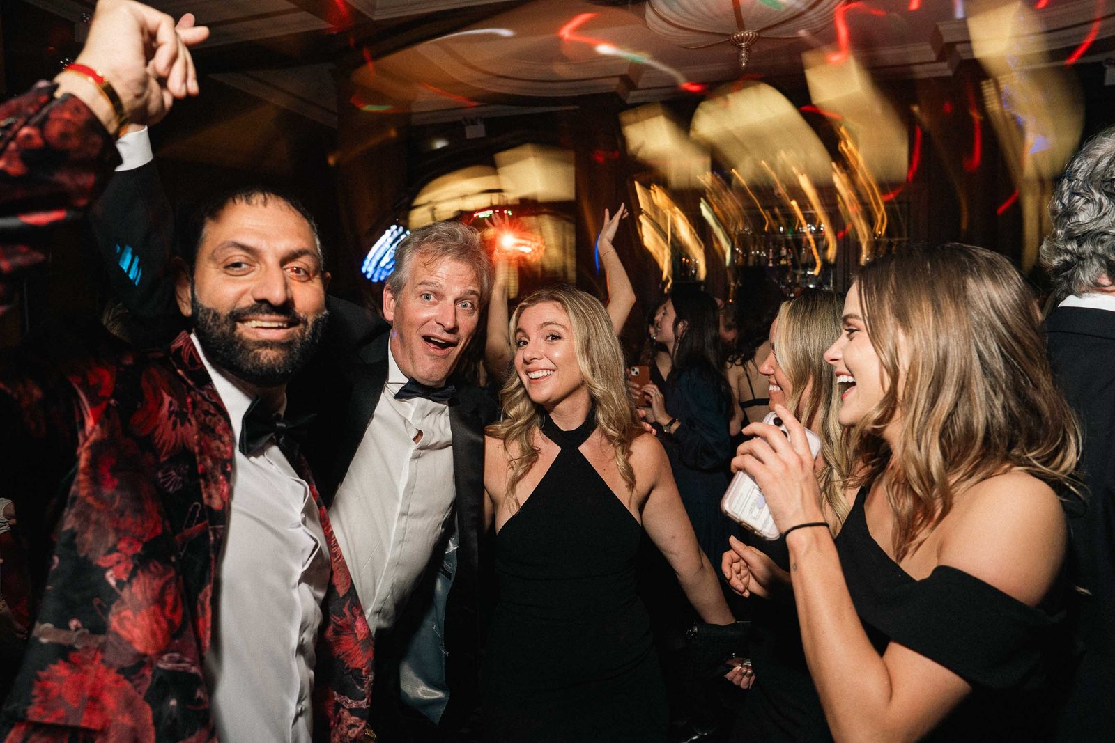 Group of friends laughing at Sailor's Ball 2024 New York City gala