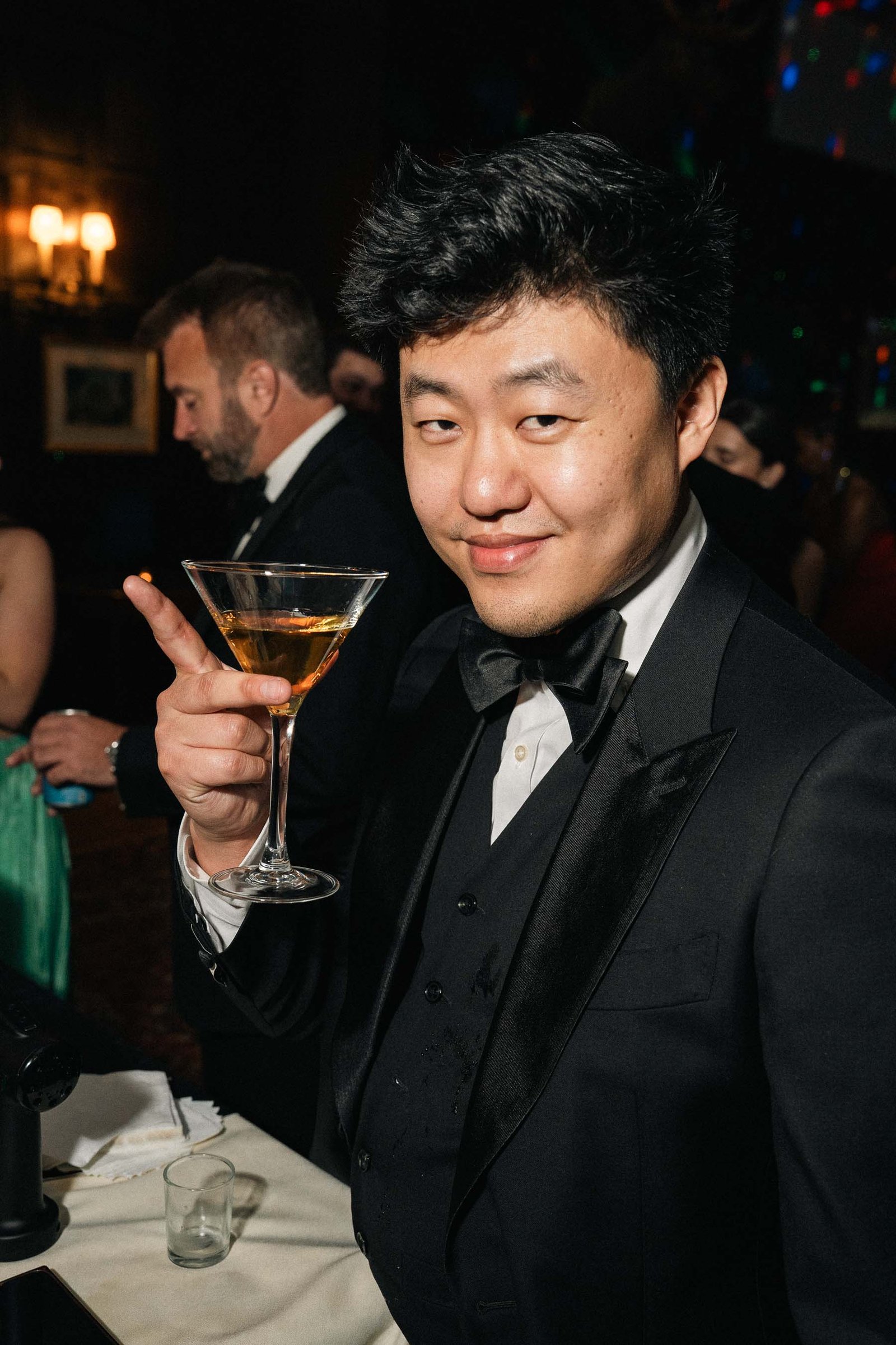 Man smiling with cocktail at Sailor's Ball 2024 NYC gala