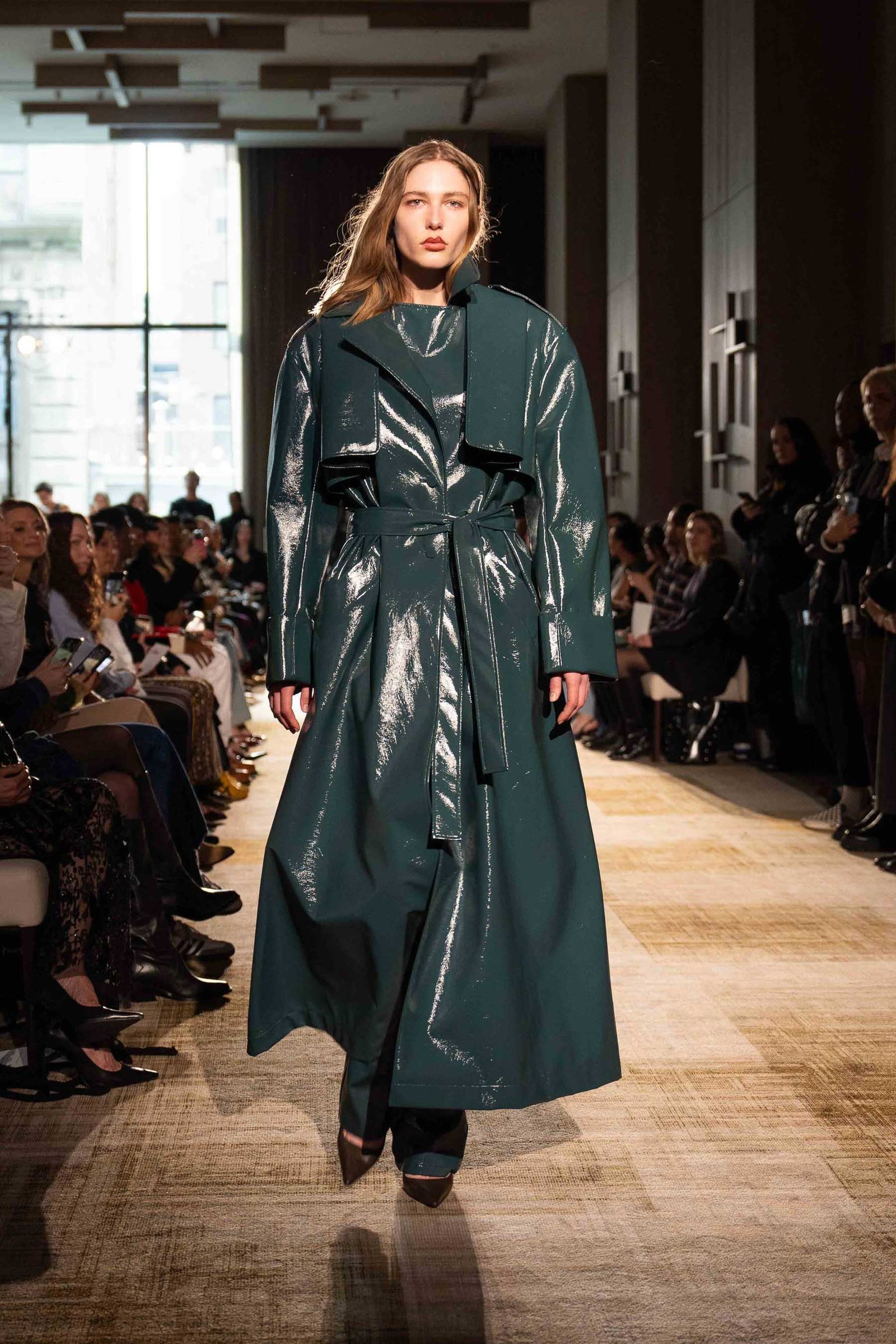 Aknvas runway model in dark green leather coat New York City